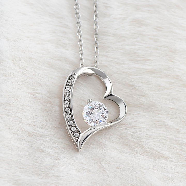 Gold finish women's necklace with a captivating heart-shaped zirconia stone. Stylish jewelry.