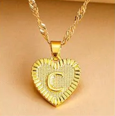 Women's gold initial heart pendant necklace, elegant personalized jewelry gift.