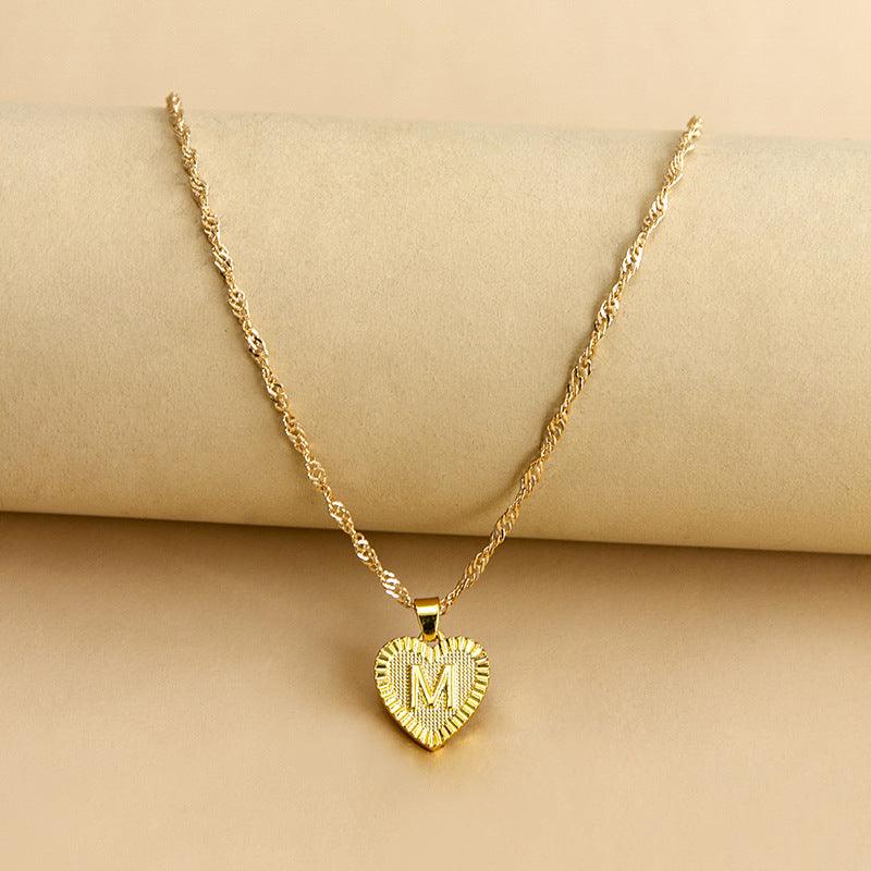 Elegant women's gold initial heart pendant, ideal for Valentine's Day.