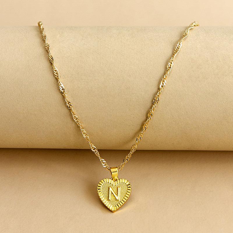 Gold initial heart necklace, a beautiful personalized women's jewelry piece.