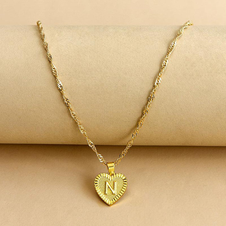 Gold initial heart necklace, a beautiful personalized women's jewelry piece.