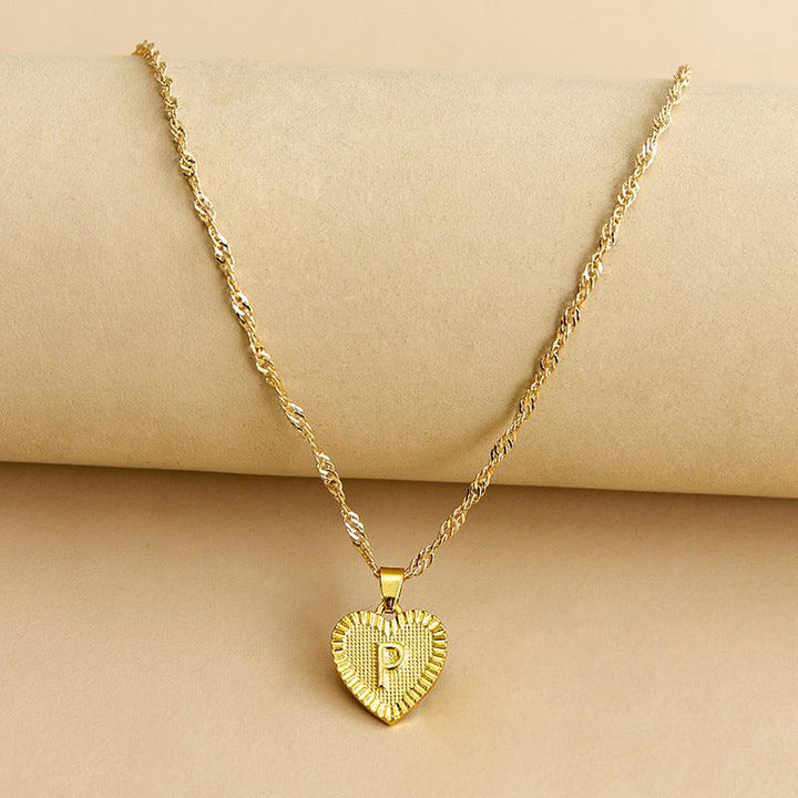 Women's custom gold initial heart necklace, a timeless and elegant accessory.