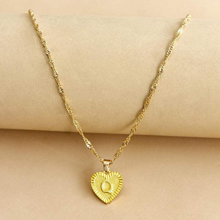 Stylish personalized gold heart initial pendant, perfect for everyday wear.
