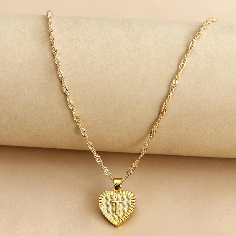 Personalized gold initial heart necklace, a stunning addition to any outfit.