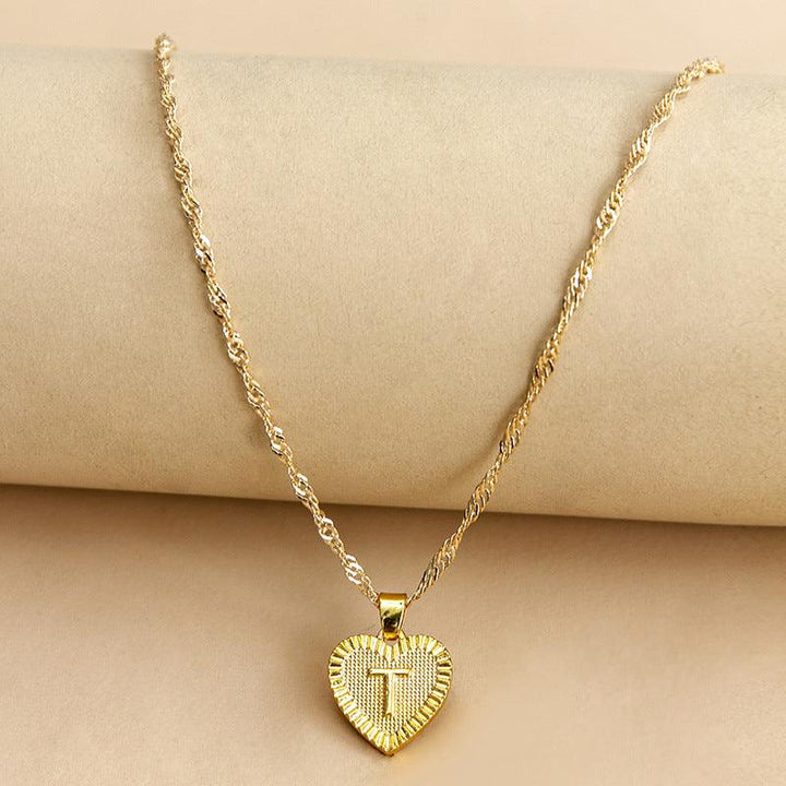Personalized gold initial heart necklace, a stunning addition to any outfit.