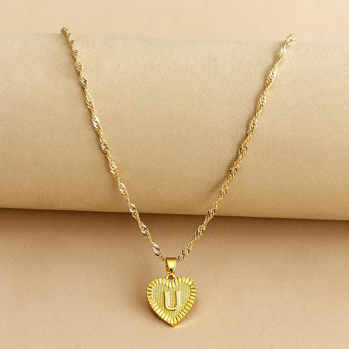 Women's gold heart initial pendant, a symbol of love, perfect custom gift.