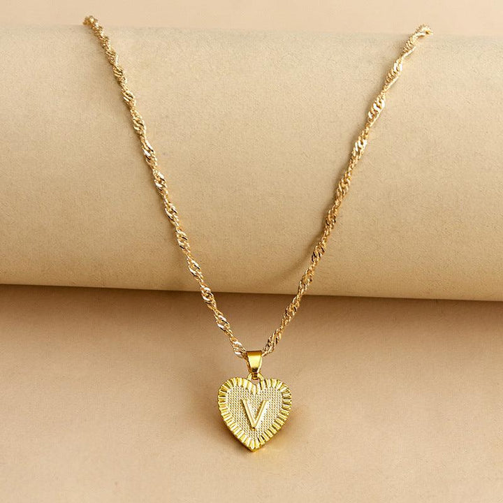 Glistening gold initial heart necklace, personalized and elegant for women.