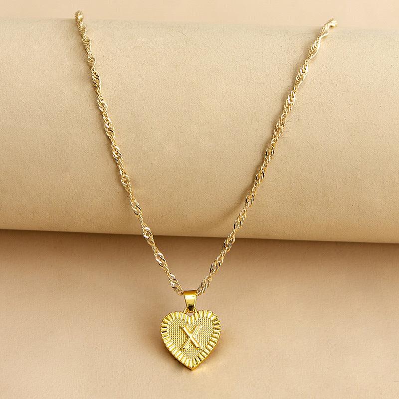 Custom gold heart initial necklace, a unique piece of women's personalized jewelry.