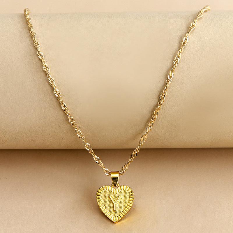 Women's elegant gold initial heart pendant, a cherished custom birthday gift.