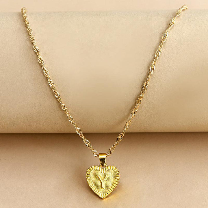 Women's elegant gold initial heart pendant, a cherished custom birthday gift.