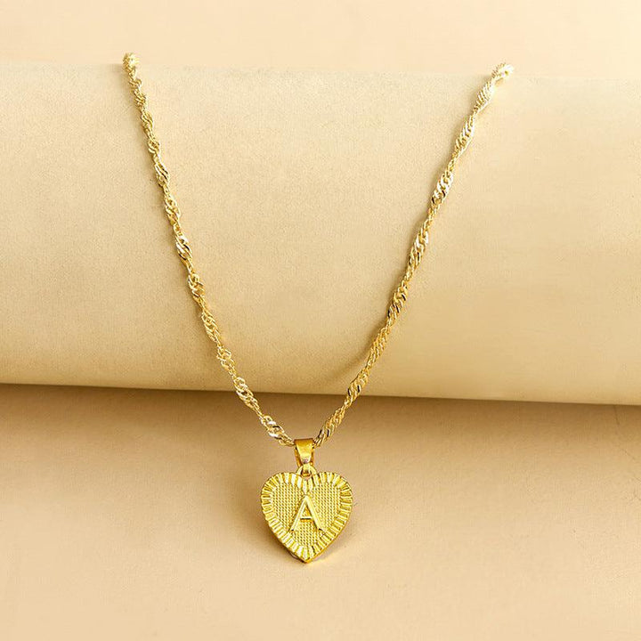 Elegant women's gold initial heart pendant, a unique custom jewelry piece.