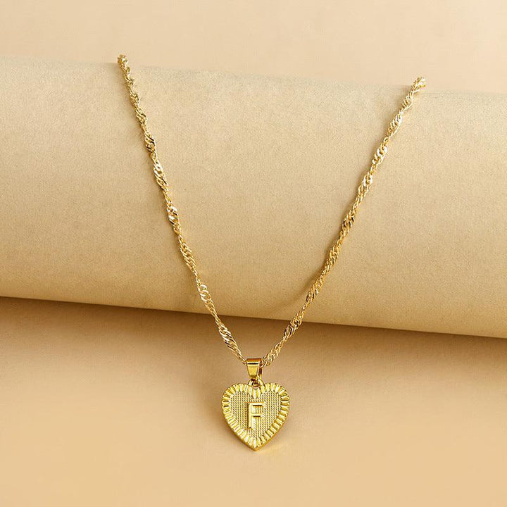 Personalized gold heart necklace with chosen initial, perfect Valentine's gift.