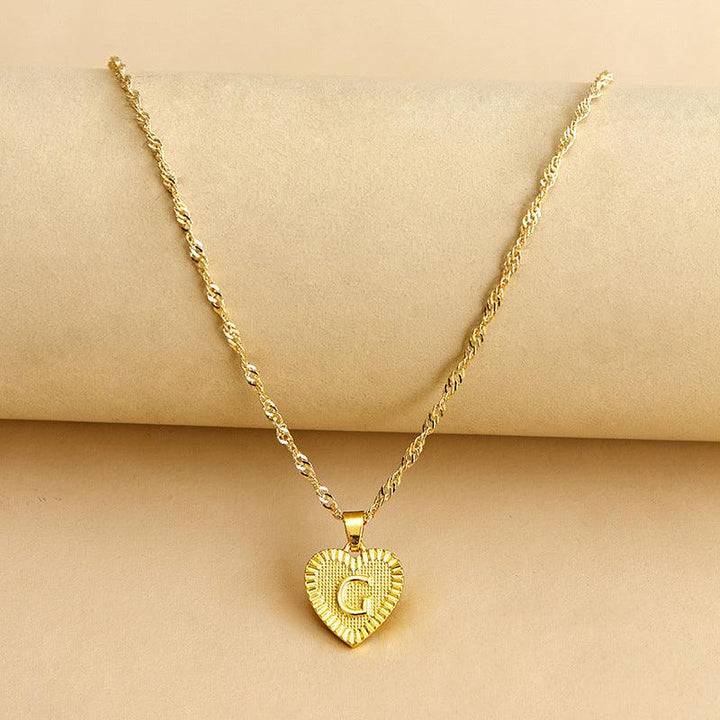 Women's custom gold initial heart pendant, unique and elegant jewelry.