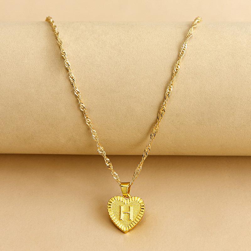 Shimmering gold initial heart necklace for women, a beautiful custom gift.