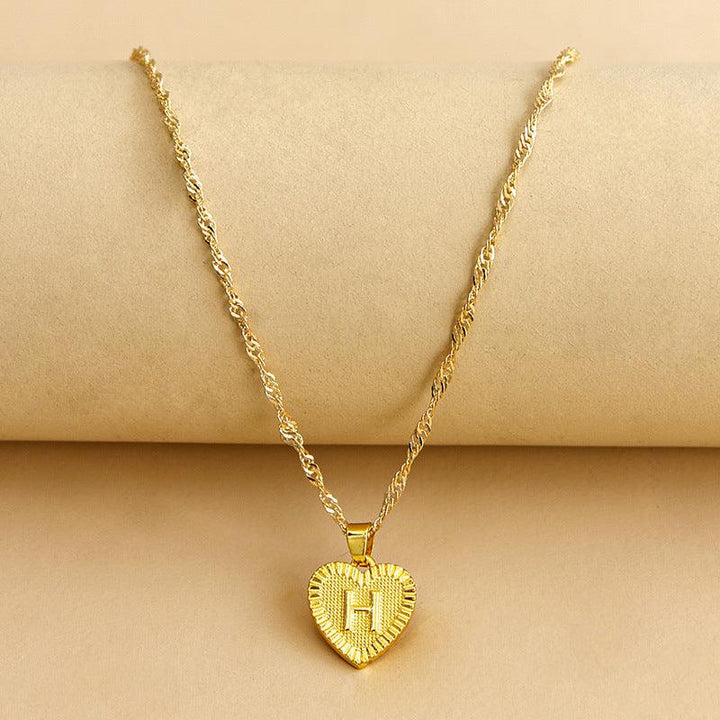 Shimmering gold initial heart necklace for women, a beautiful custom gift.