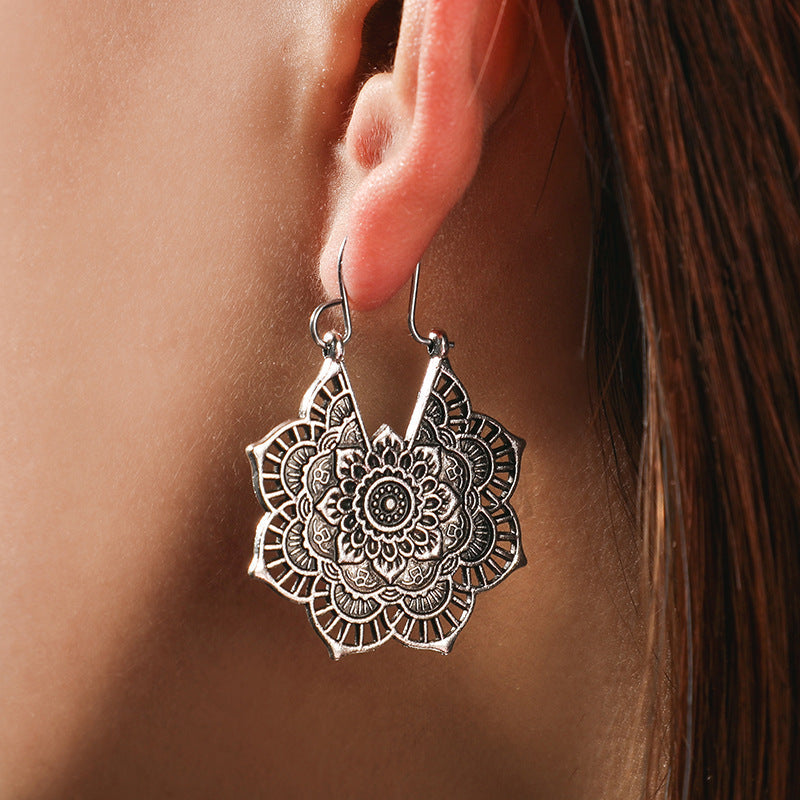 Women's gold lotus mandala drop earrings, elegant spiritual boho jewelry.
