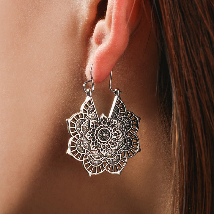 Women's gold lotus mandala drop earrings, elegant spiritual boho jewelry.