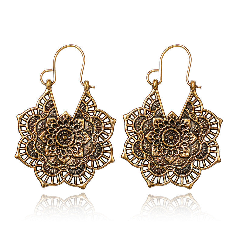 Elegant women's gold drop earrings with intricate lotus mandala design, ideal for special occasions.