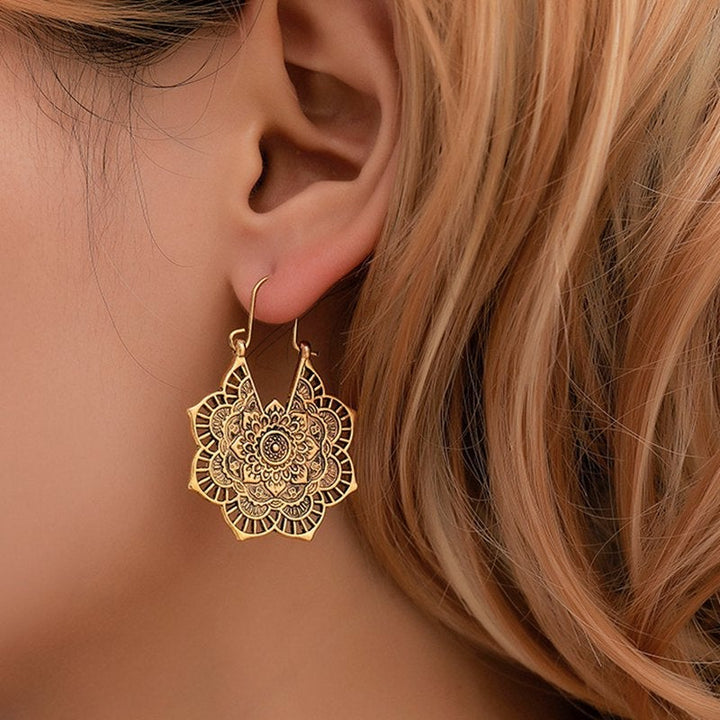Intricate lotus mandala drop earrings for women, spiritual boho chic gold jewelry.