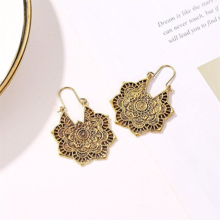 Stylish silver lotus mandala drop earrings, elegant and spiritual boho accessory for women.