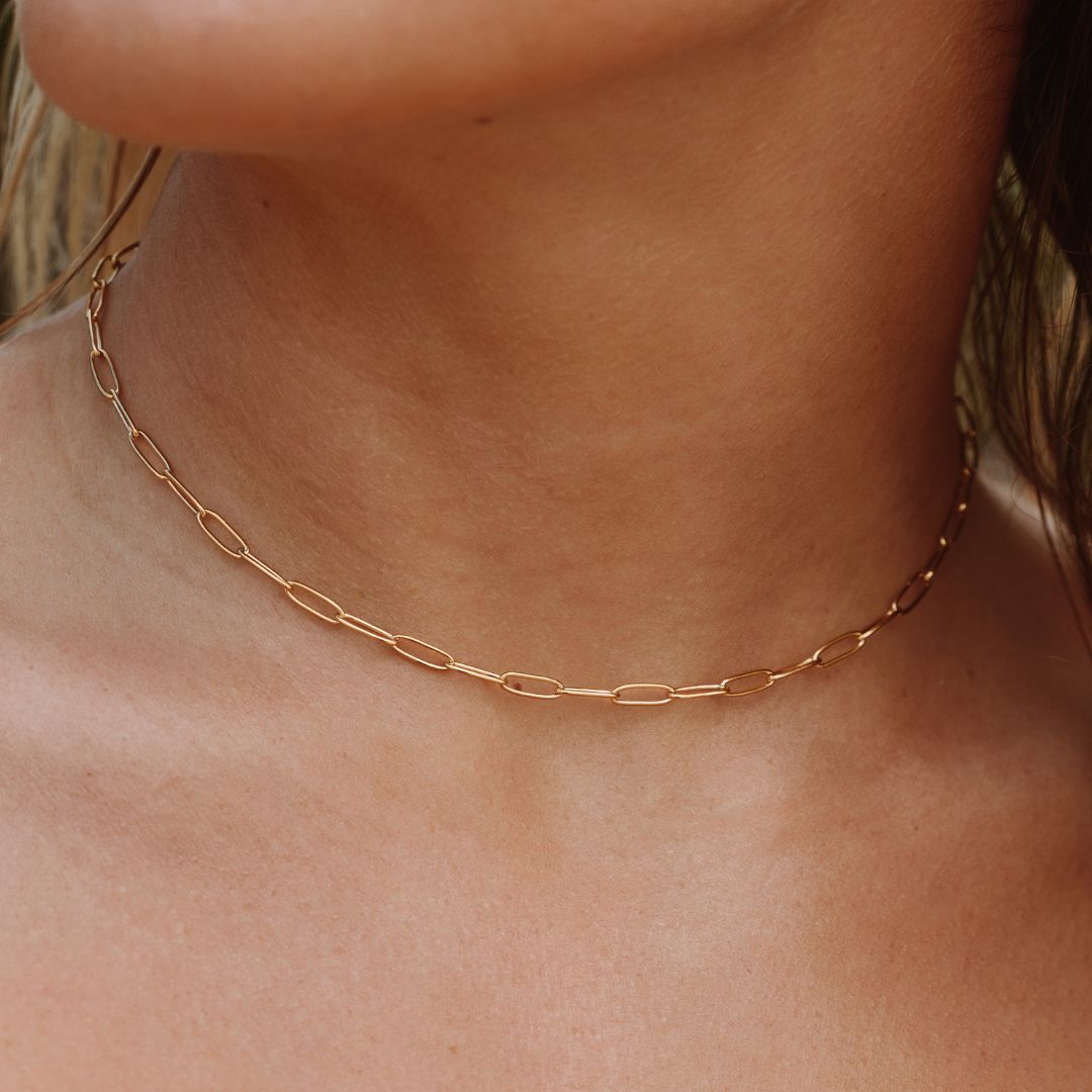 Women's gold paperclip choker necklace, adjustable & minimalist, perfect for everyday wear.