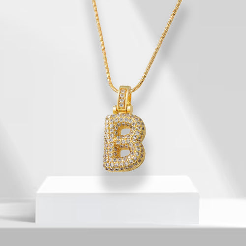 Close-up of sparkling zirconia bubble letter 'A' necklace, a chic gold plated women's statement jewelry piece.