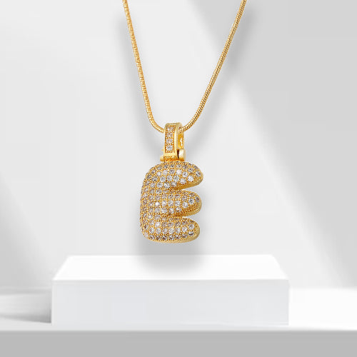 Bubble letter initial necklace, gold plated with zirconia, a glamorous fashion accessory for women.