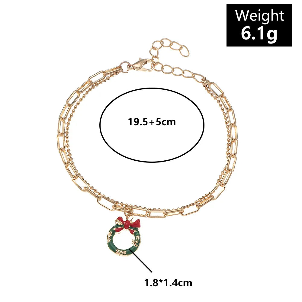 Seasonal gold-plated charm bracelet, festive Christmas accessory with colorful enamel details.