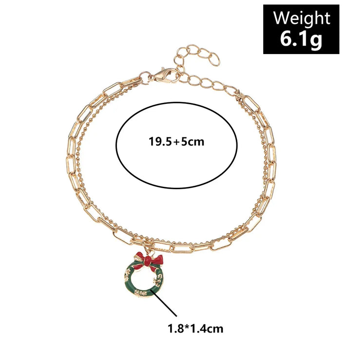 Seasonal gold-plated charm bracelet, festive Christmas accessory with colorful enamel details.