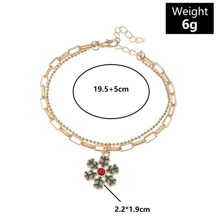 Women's festive gold-plated Christmas charm bracelet, a beautiful enamel holiday accessory.