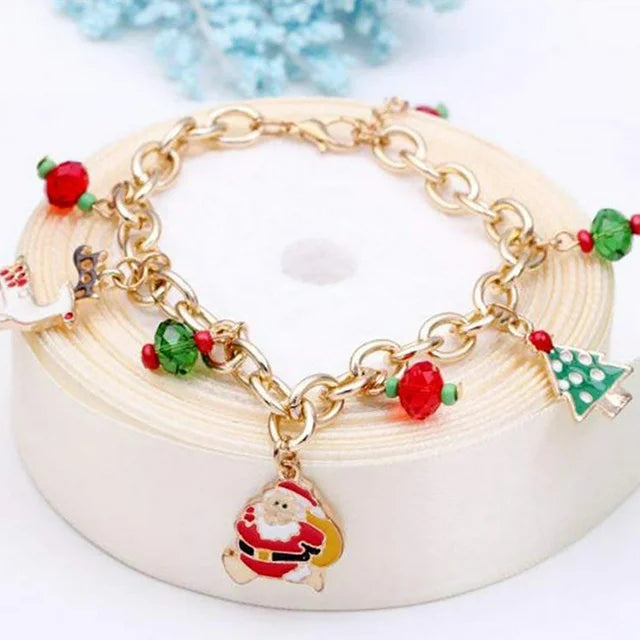 Elegant women's holiday charm bracelet, gold-plated with festive Christmas charms and sparkling rhinestones.