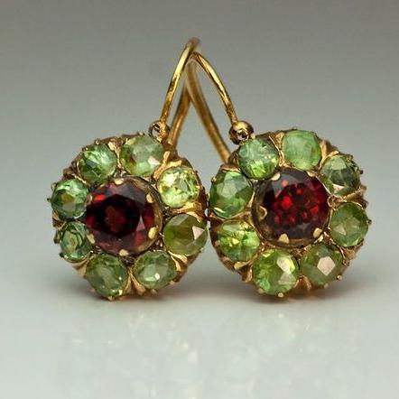 Women's gold-plated drop earrings with sparkling green and red crystals. Elegant statement jewelry for women.