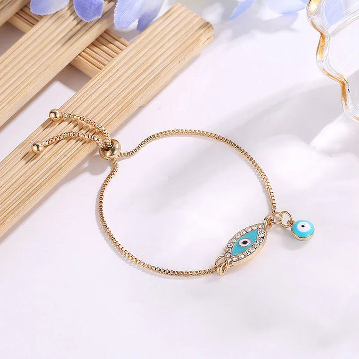 Sparkling gold plated evil eye bracelet for women, offering spiritual protection in a trendy ethnic boho jewelry style.