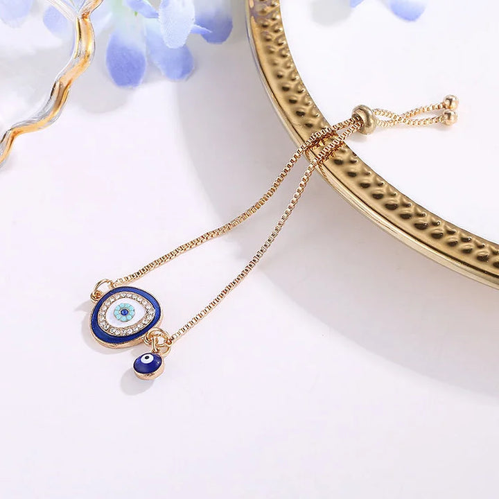 Stylish women's gold plated evil eye bracelet, featuring a detailed sparkling blue charm for spiritual & ethnic fashion.