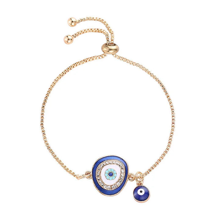 Boho chic women's evil eye protection bracelet, gold plated with a sparkling blue charm, embodying ethnic spiritual style.