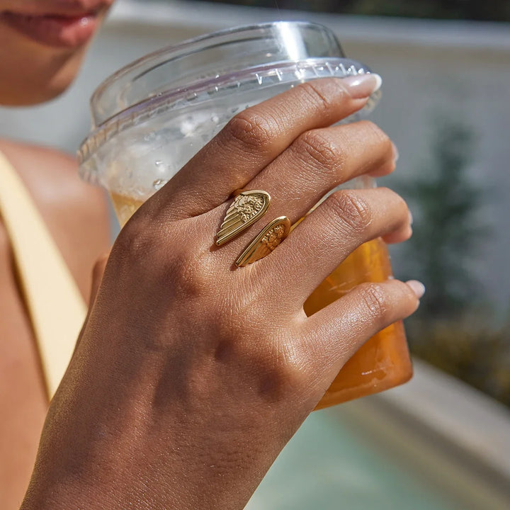 Gold plated stainless steel women's feather angel wing ring, adjustable celestial jewelry, symbol of protection.