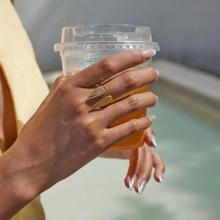 Elegant gold plated women's guardian angel wing ring, adjustable stainless steel celestial feather jewelry.