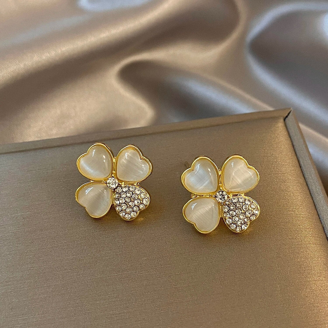 Hypoallergenic sterling silver four-leaf clover drop earrings for women. Gold-plated lucky charm jewelry gift.