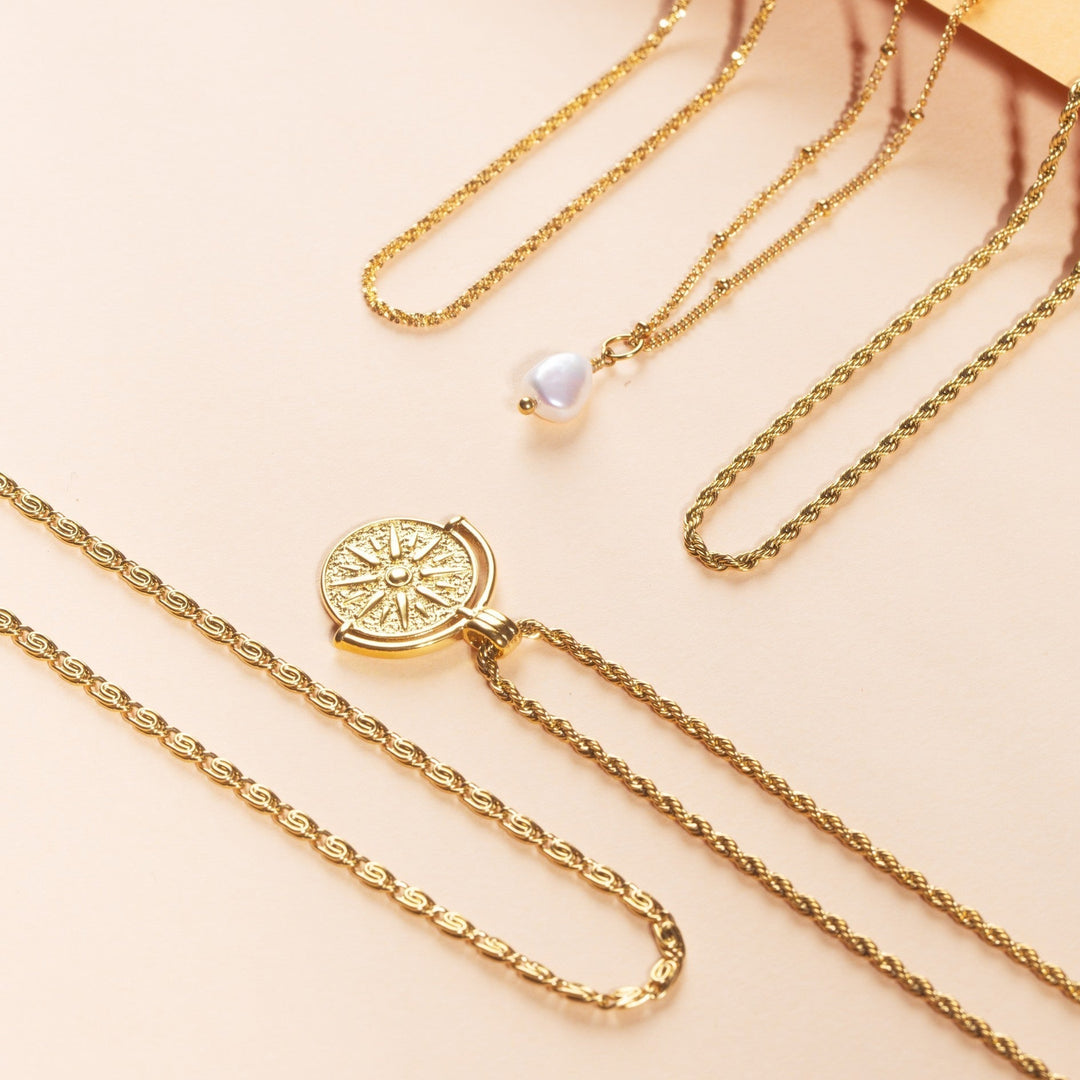 Hypoallergenic gold sun pendant necklace, ideal women's celestial jewelry.