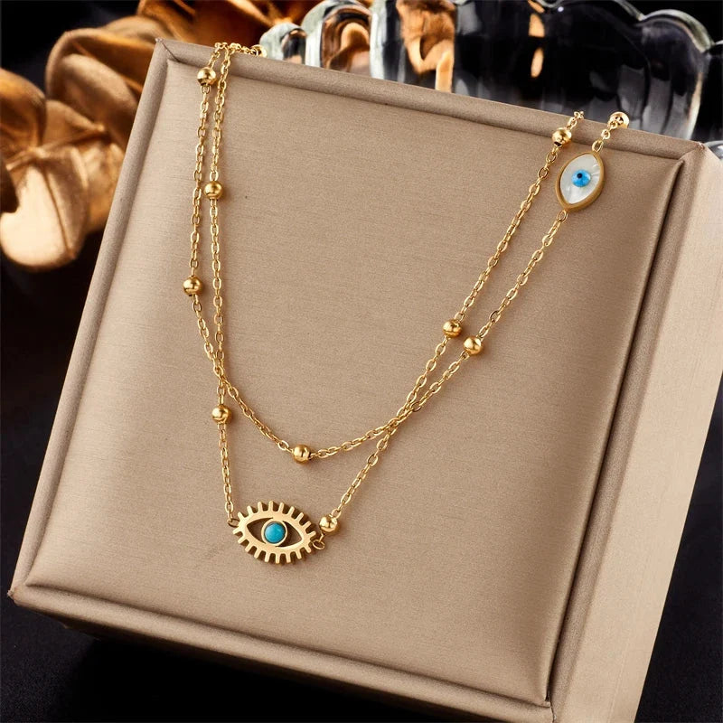 Women's gold tone layered necklace with evil eye charm, a stylish protection jewelry accessory for women.