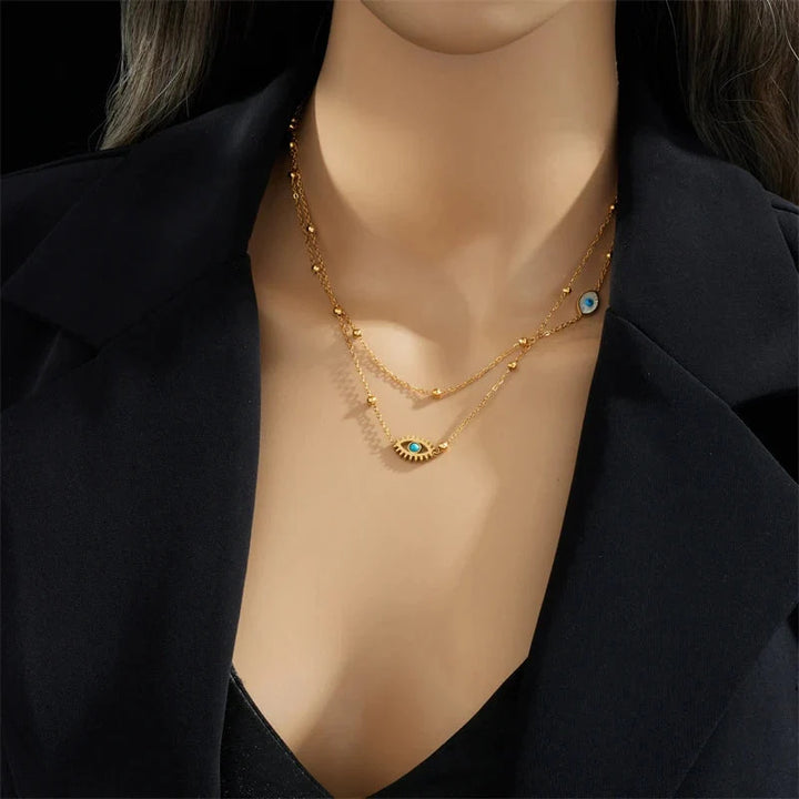Stylish women's gold layered necklace with evil eye charm, a trendy protection accessory for women's fashion.