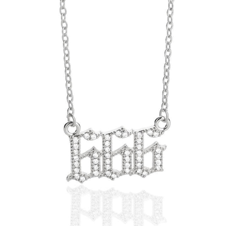 Close-up of a delicate silver zirconia angel numbers protection necklace.