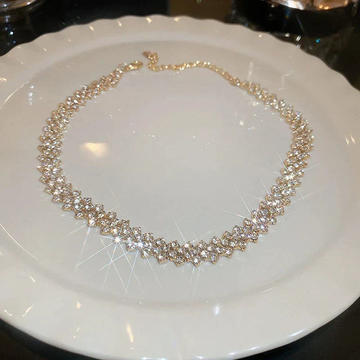 Close-up of Golden Gala Rhinestone Geometric Necklace, intricate gold design with sparkling crystals.