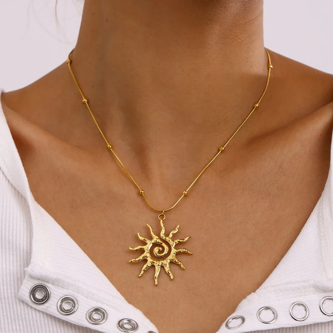 Women's golden hammered sun charm necklace, elegant stainless steel jewelry for a bohemian look.
