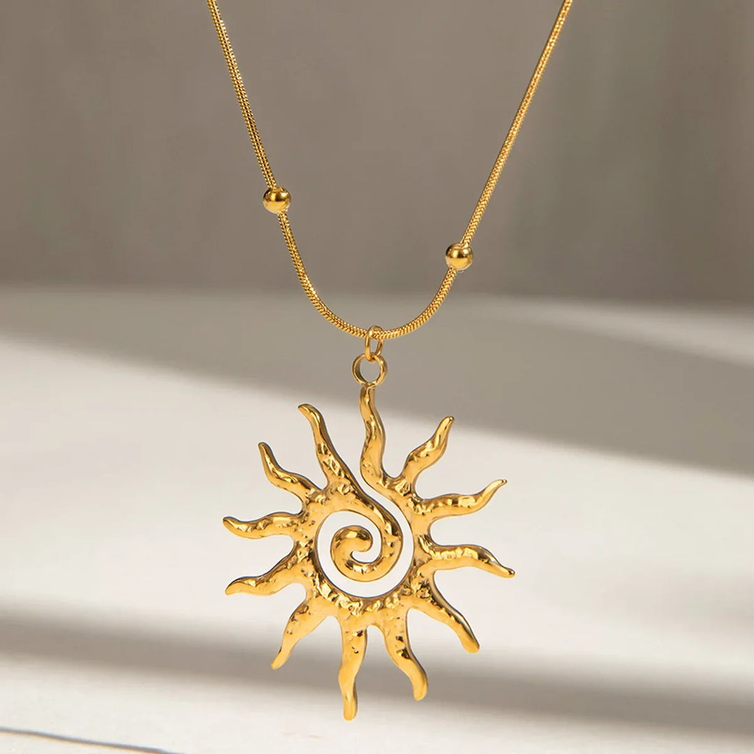 Close-up of a golden hammered sun charm necklace, adjustable women's jewelry with a unique texture.