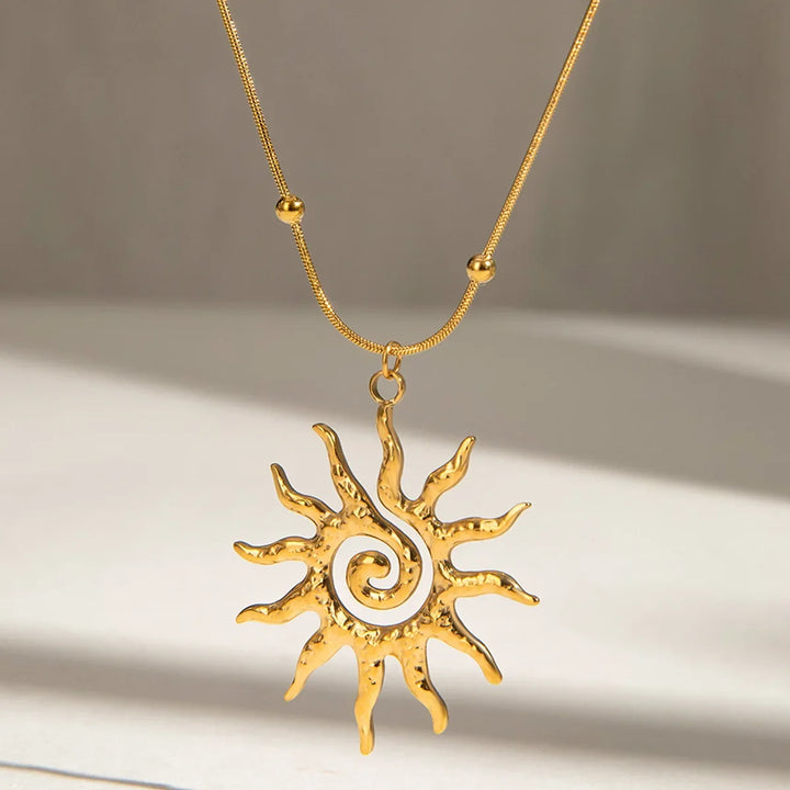 Close-up of a golden hammered sun charm necklace, adjustable women's jewelry with a unique texture.