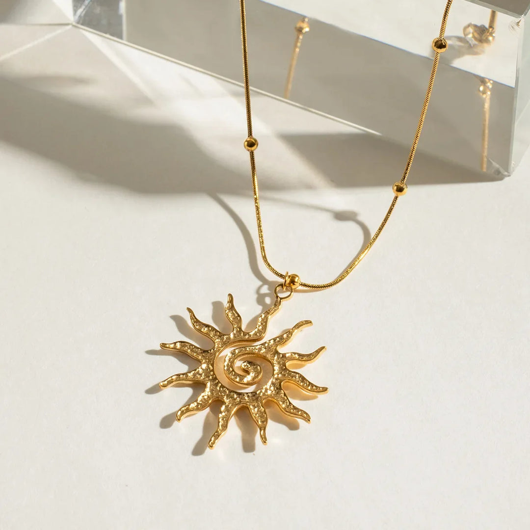 Stylish golden sun charm necklace for women, featuring a hammered design on durable stainless steel.