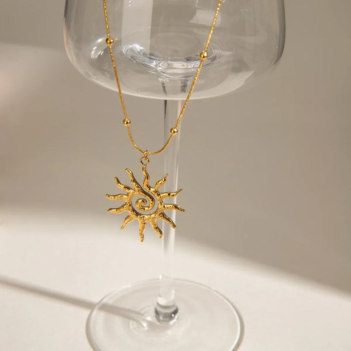 Adjustable women's necklace with a radiant golden hammered sun charm, versatile and chic jewelry.