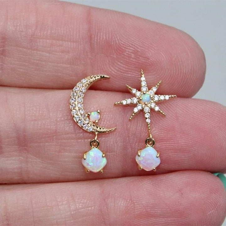 Fashionable women's golden moon and star stud earrings adorned with shimmering opal, celestial gift.