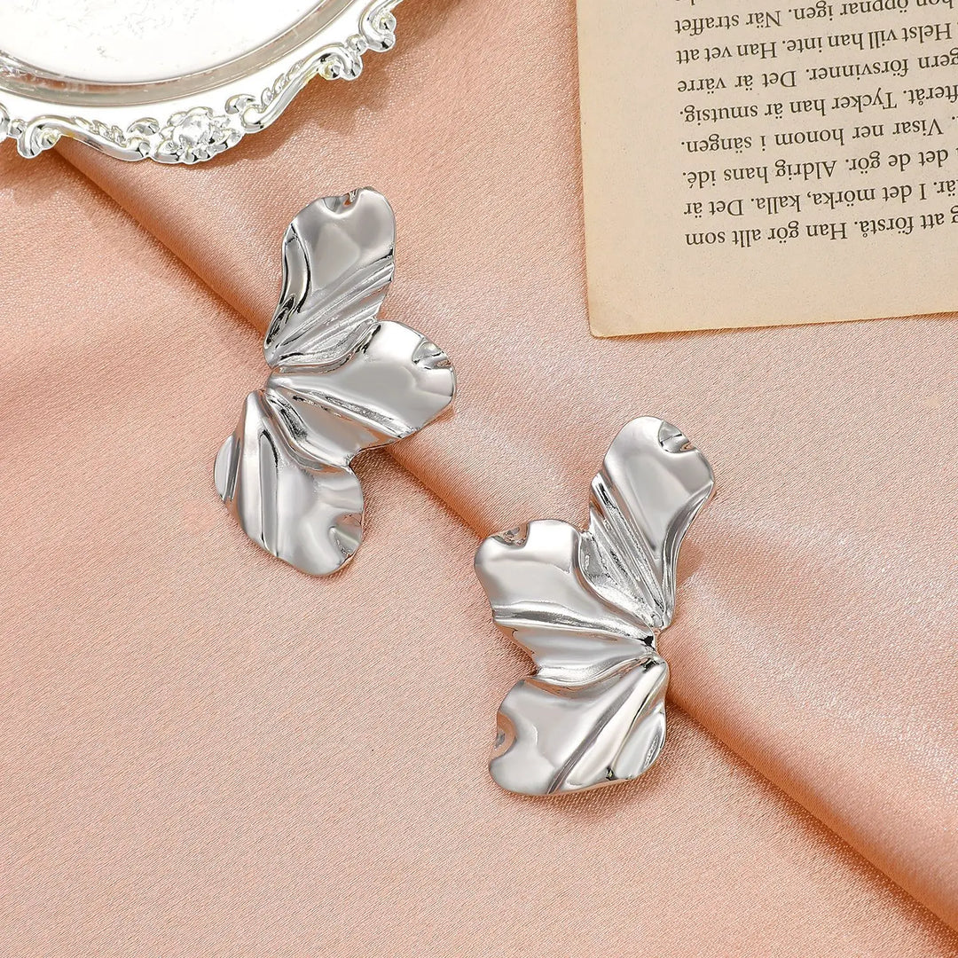 Golden floral stud earrings for women, featuring an elegant petal design.